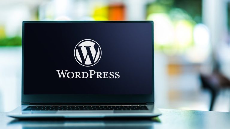 laptop computer displaying logo of wordpress